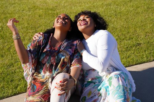 Two women share a comforting moment by a window, conveying emotion and support.