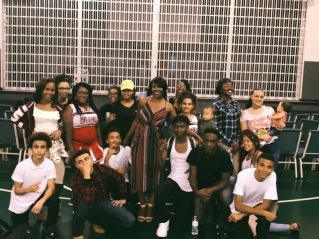 A loving embrace between an interracial couple in a bright, sunlit indoor setting, expressing warmth and affection.